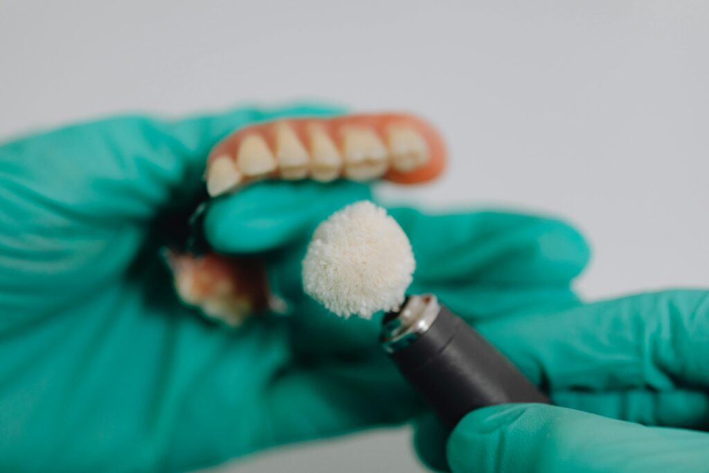 A close up shot of a person polishing dentures